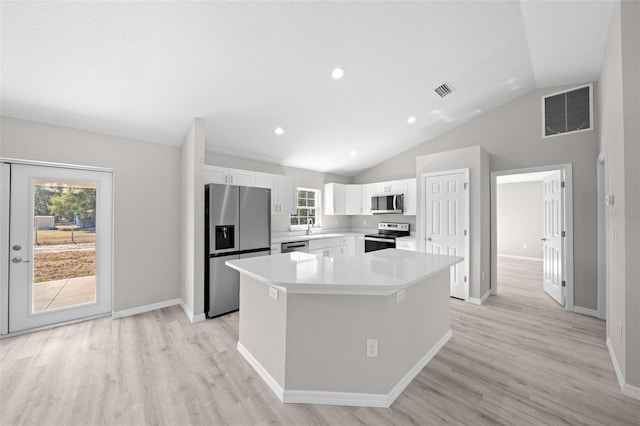 kitchen featuring sink, light wood-type flooring, a kitchen island, white cabinetry, and stainless steel appliances