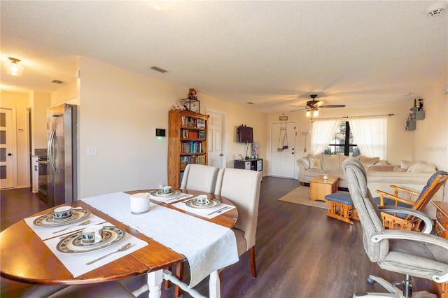 dining area with dark hardwood / wood-style flooring, a textured ceiling, and ceiling fan