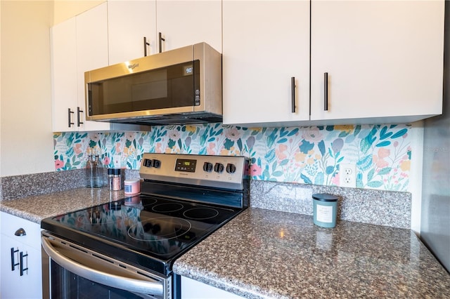 kitchen featuring white cabinetry, backsplash, and appliances with stainless steel finishes