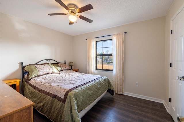 bedroom with a textured ceiling, ceiling fan, and dark hardwood / wood-style floors