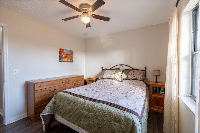 bedroom with ceiling fan and dark hardwood / wood-style flooring