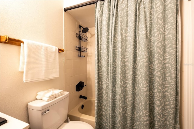 bathroom featuring shower / bath combo with shower curtain and toilet