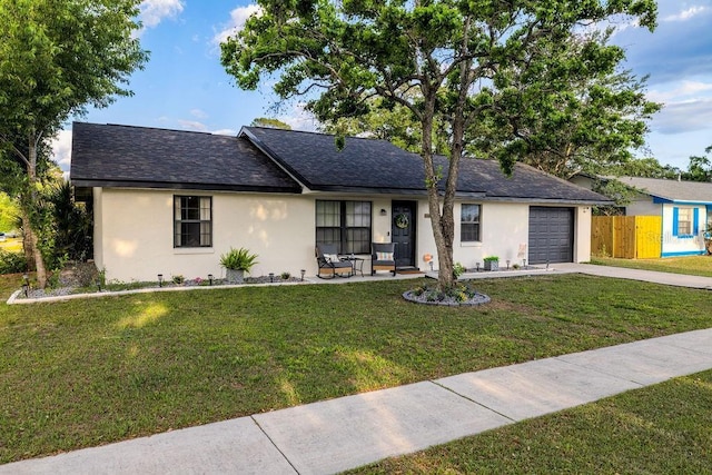 single story home with a garage, stucco siding, fence, a front lawn, and concrete driveway