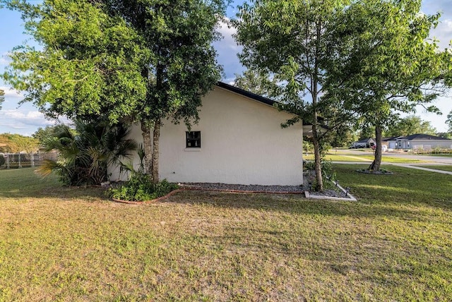 view of property exterior featuring a yard and stucco siding