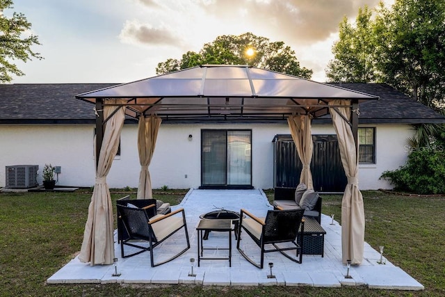 back of house with a gazebo, stucco siding, central AC, and a yard