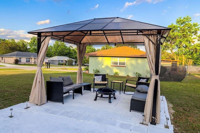 view of patio / terrace with an outdoor fire pit, a gazebo, and fence