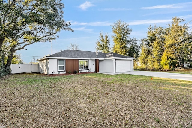 ranch-style house with concrete driveway, an attached garage, a front yard, a gate, and fence