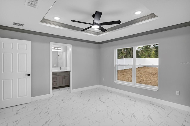 unfurnished bedroom featuring ceiling fan, ornamental molding, and connected bathroom