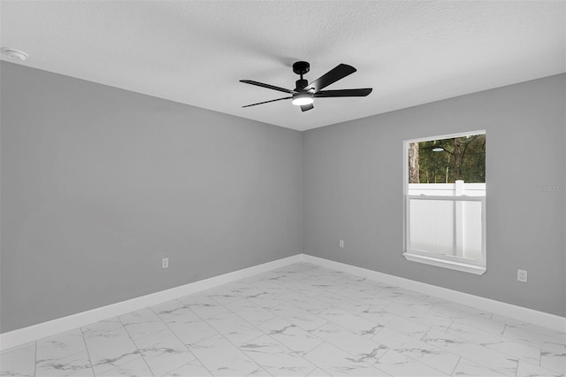 spare room with ceiling fan and a textured ceiling