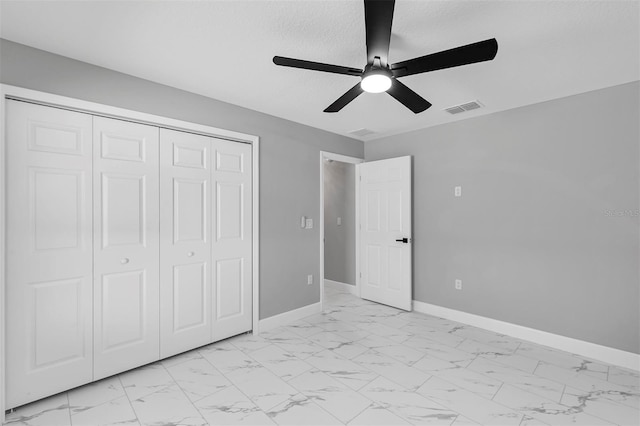 unfurnished bedroom with a textured ceiling, a closet, and ceiling fan