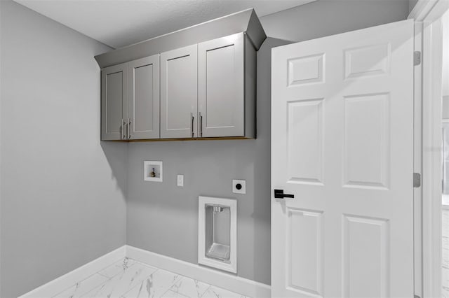 clothes washing area featuring hookup for a washing machine, cabinets, a textured ceiling, and hookup for an electric dryer