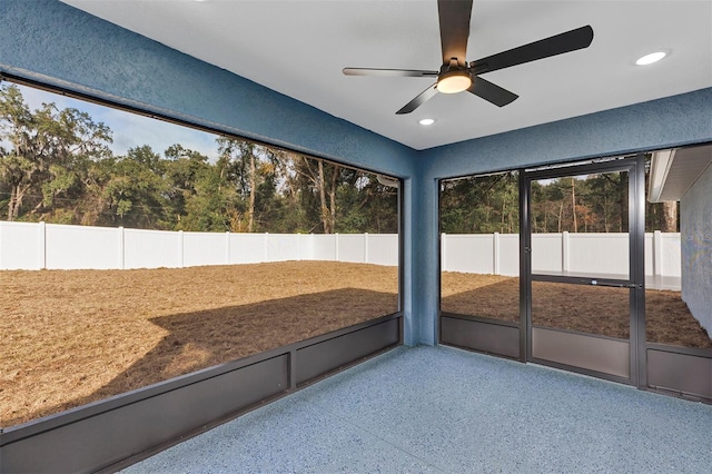 unfurnished sunroom featuring ceiling fan