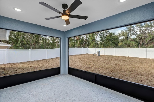 unfurnished sunroom featuring ceiling fan