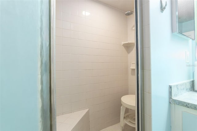 bathroom featuring vanity and a tile shower