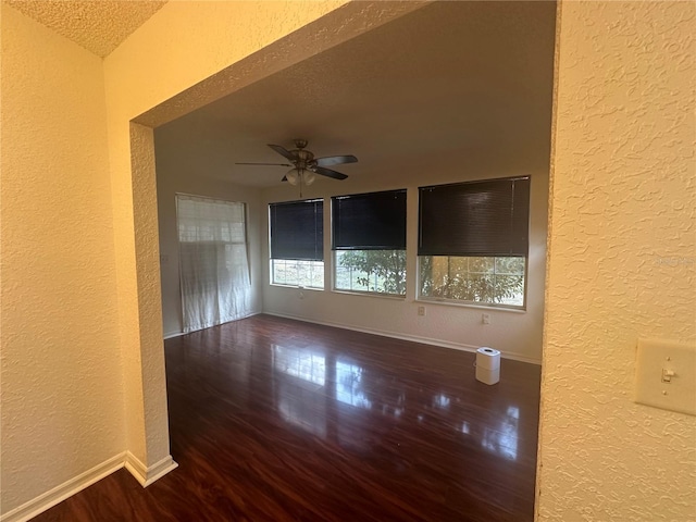 unfurnished room featuring a textured ceiling, ceiling fan, vaulted ceiling, and wood-type flooring