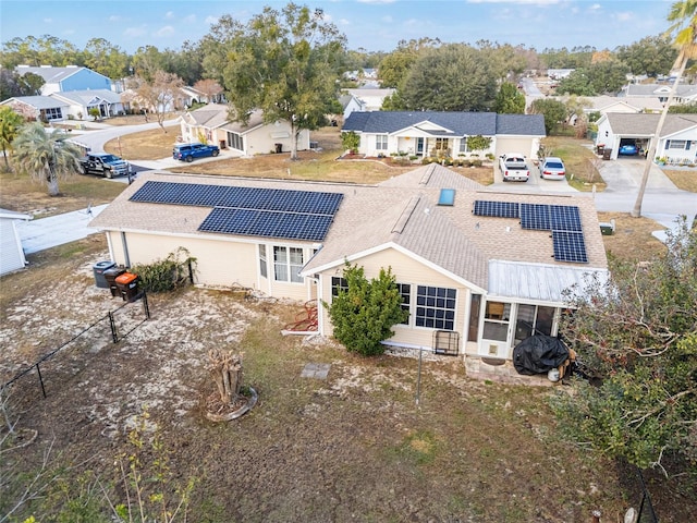 rear view of house featuring a residential view and solar panels