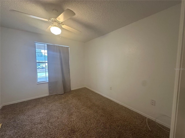 empty room with ceiling fan, a textured ceiling, and carpet flooring