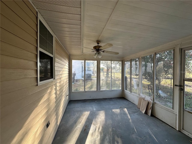 unfurnished sunroom featuring ceiling fan