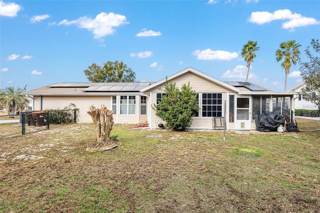 8968 SW 116th Place Rd, Ocala, FL 34481 - rear view of house featuring a sunroom, roof mounted solar panels, and a gate