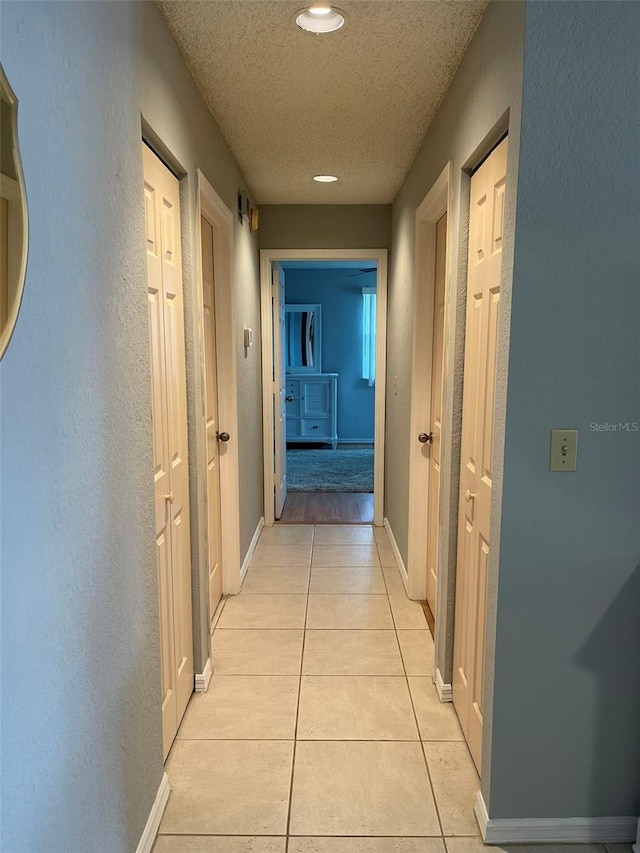 hall with light tile patterned floors