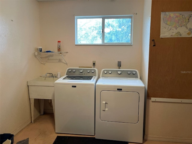 clothes washing area with washing machine and dryer