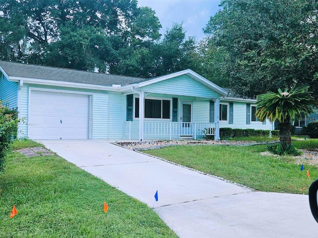 ranch-style home featuring a porch, a garage, and a front lawn