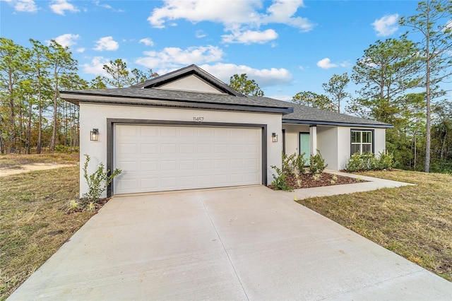 view of front of home featuring a garage and a front lawn