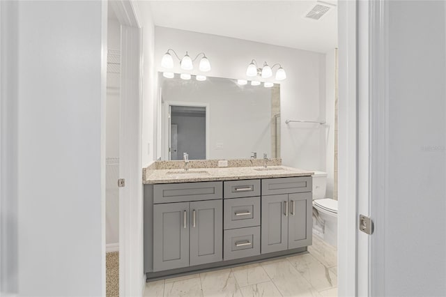 bathroom with vanity and toilet