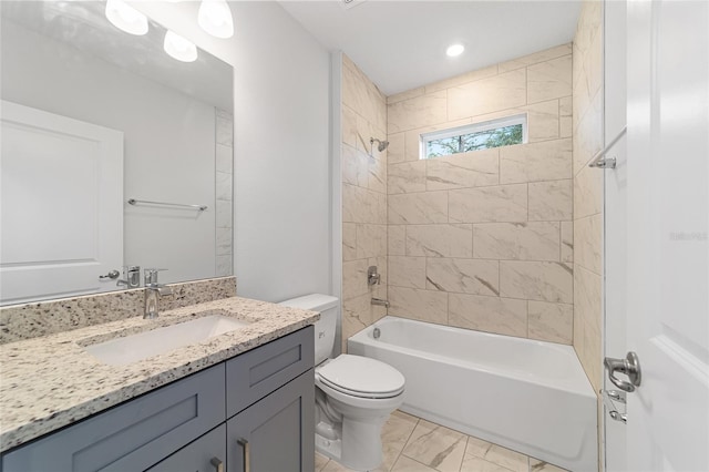 full bathroom with tiled shower / bath combo, toilet, and vanity