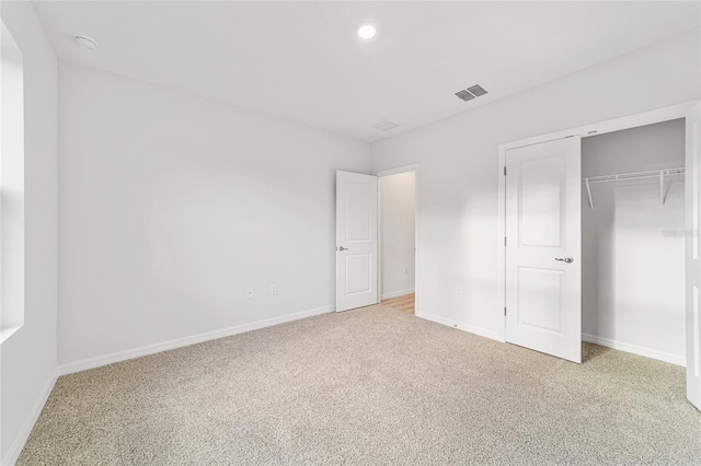 unfurnished bedroom with carpet and a closet