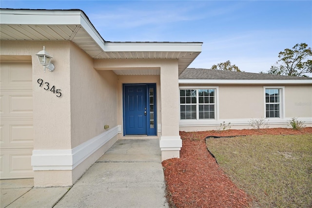 view of exterior entry featuring a garage