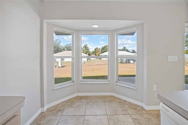 unfurnished dining area with plenty of natural light