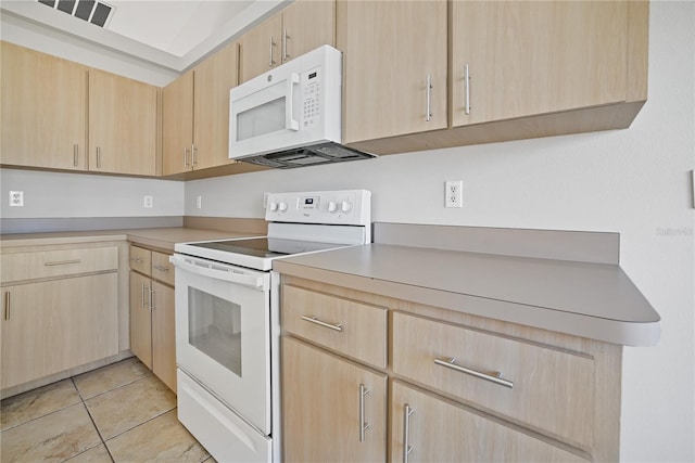 kitchen featuring light brown cabinets, light tile patterned flooring, and white appliances