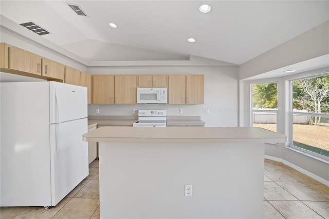 kitchen with white appliances, light brown cabinets, light tile patterned floors, a kitchen island, and lofted ceiling