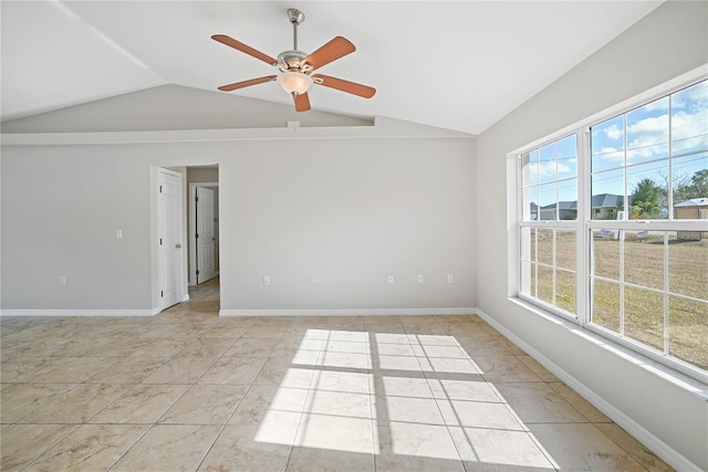 spare room with a wealth of natural light, light tile patterned floors, ceiling fan, and lofted ceiling