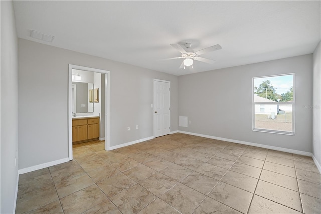 unfurnished bedroom with ensuite bathroom and ceiling fan