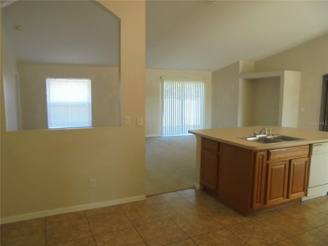 kitchen with dishwasher, kitchen peninsula, light tile patterned flooring, and sink