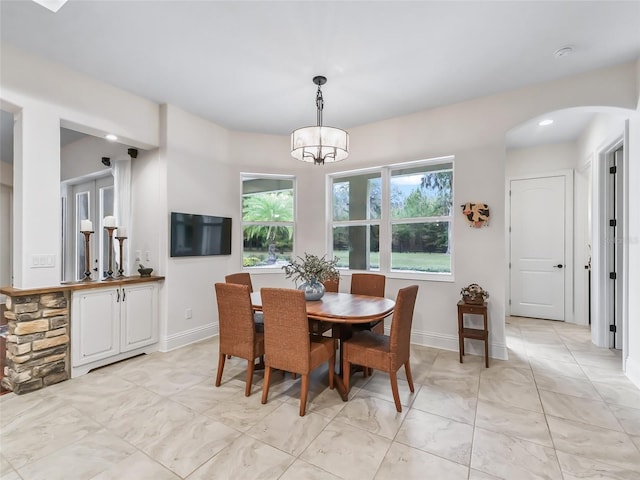 dining area with an inviting chandelier