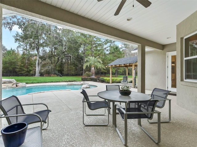 view of swimming pool featuring a gazebo, ceiling fan, a yard, and a patio