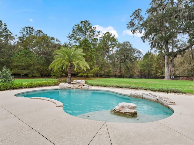 view of pool featuring a lawn