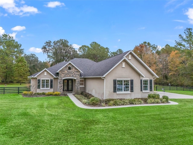 ranch-style house with french doors and a front yard