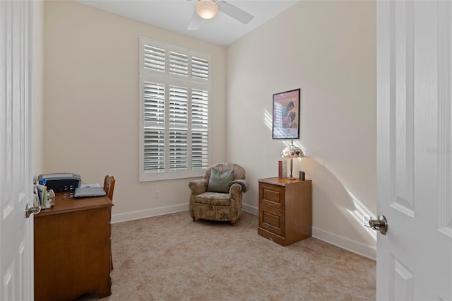 living area featuring light colored carpet and ceiling fan