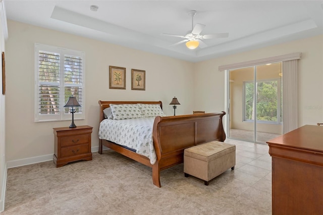 bedroom featuring a tray ceiling and ceiling fan