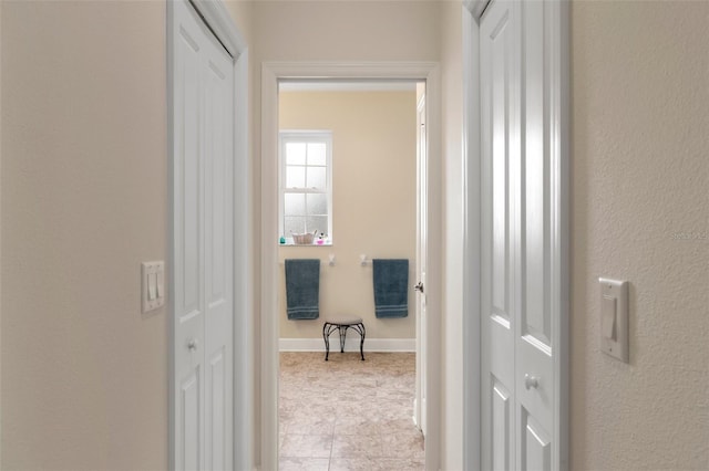 hallway featuring light tile patterned floors