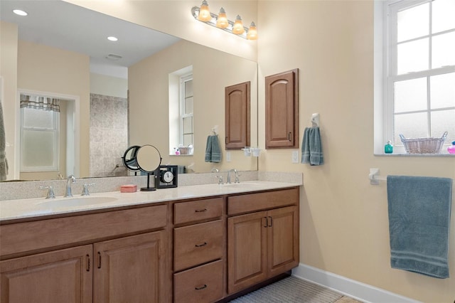 bathroom with tile patterned flooring, vanity, and plenty of natural light