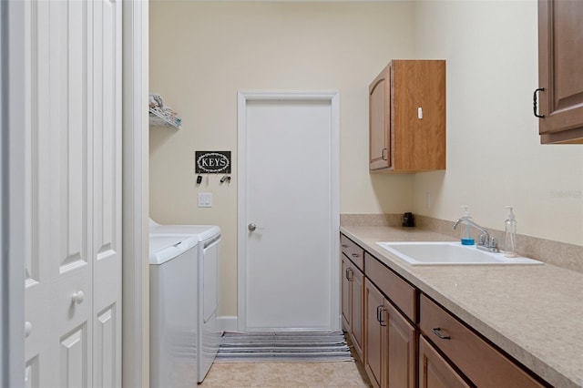 laundry room featuring washing machine and dryer, sink, light tile patterned flooring, and cabinets