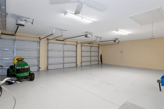 garage with ceiling fan and a garage door opener