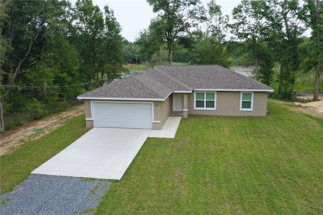 view of front of property with a front yard and a garage