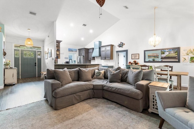 living room featuring ceiling fan, high vaulted ceiling, and dark hardwood / wood-style floors