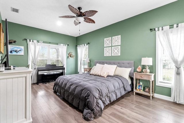 bedroom with light hardwood / wood-style flooring and ceiling fan